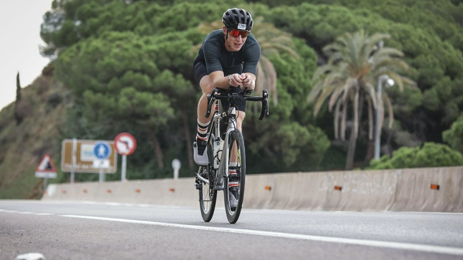 Cyclist in an aero tuck riding a road bike